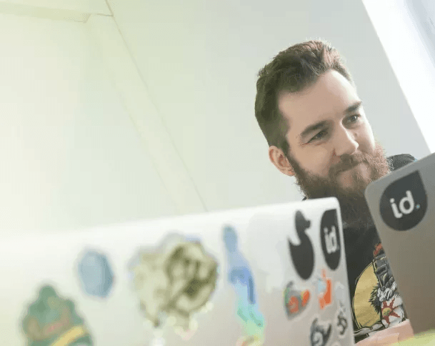 Identio team member at work with laptops